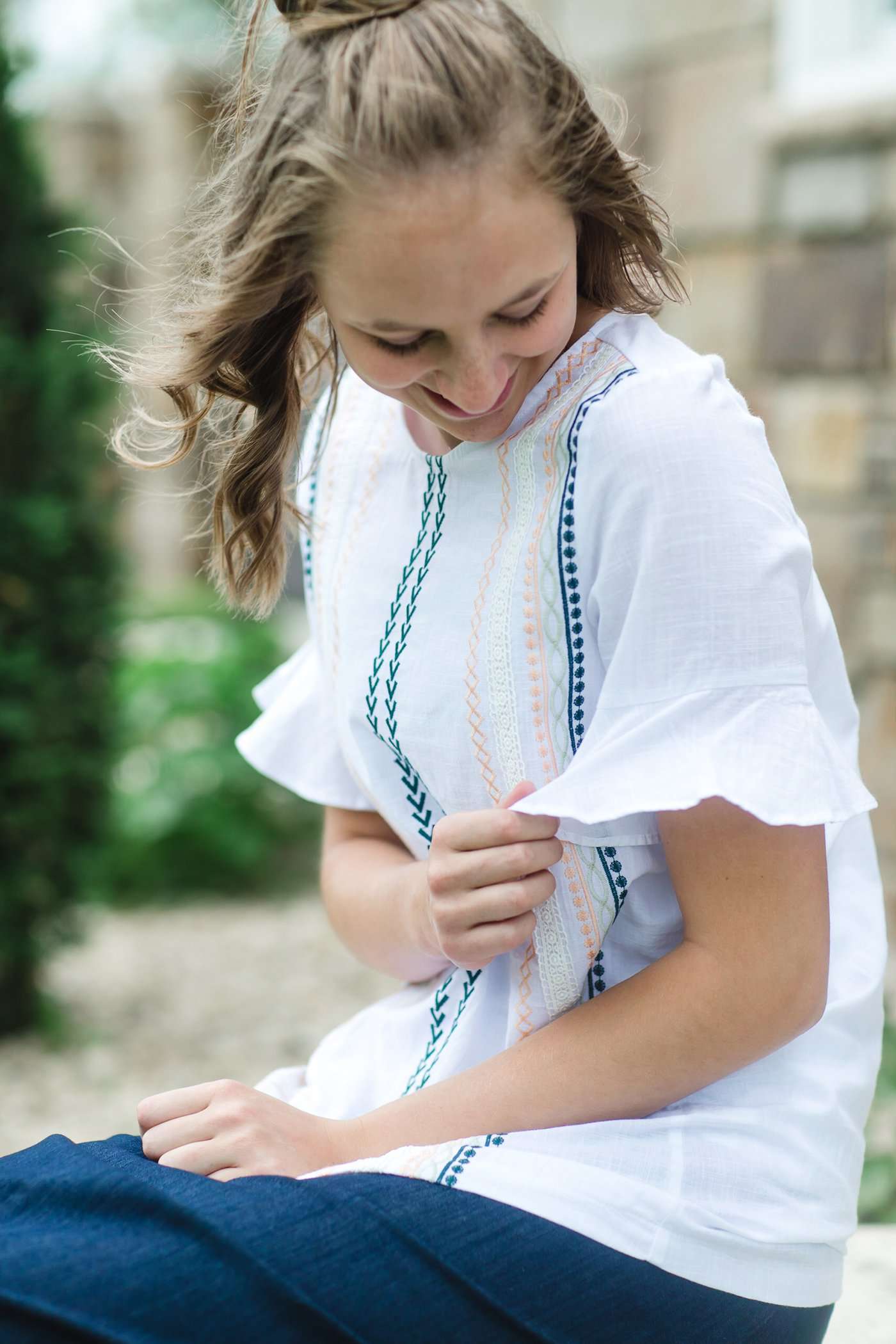 Modest white belle-sleeve top with Earthy colored embroidery down the front.