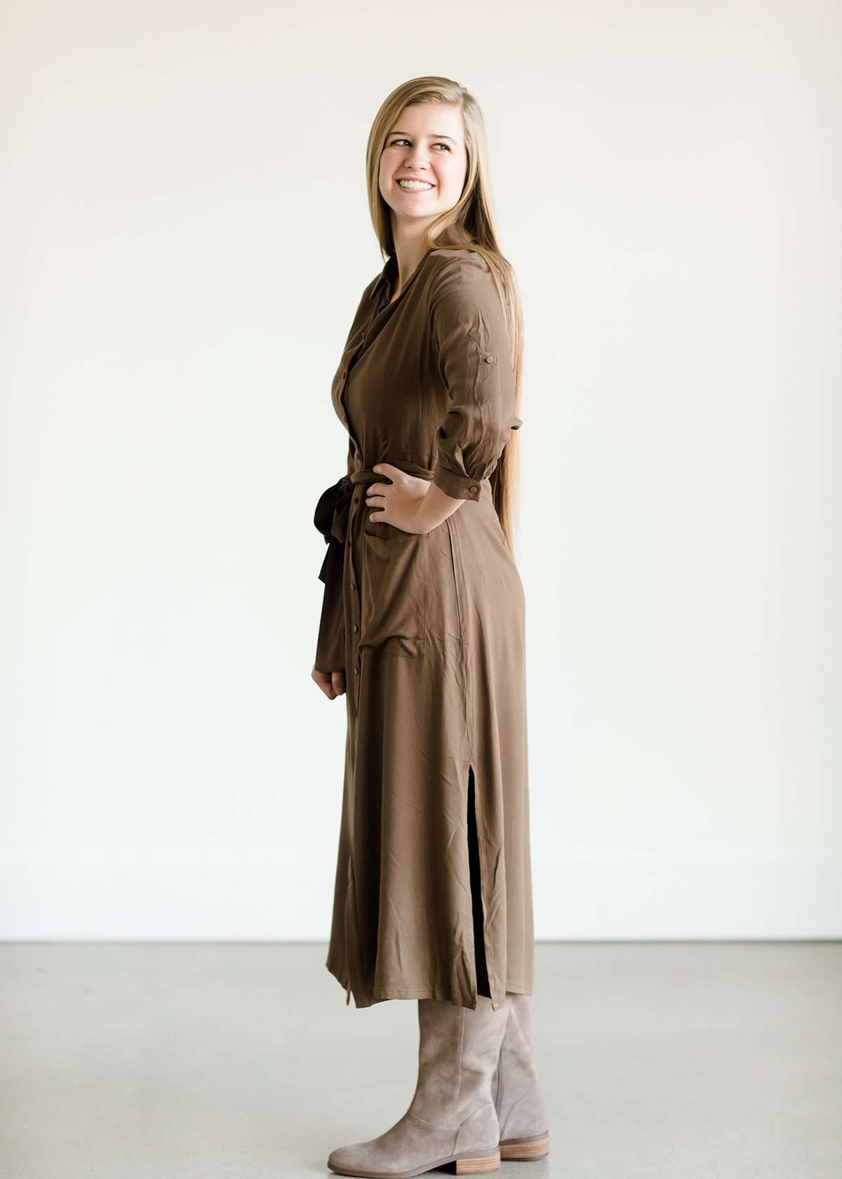 Olive colored belted midi dress with buttons running down the front.