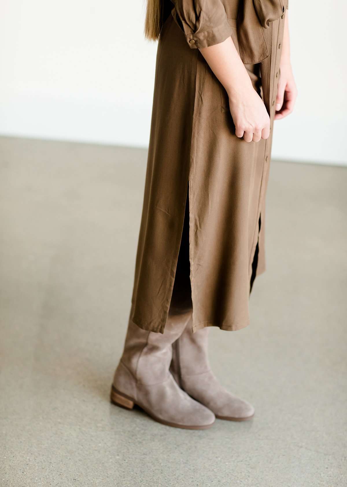 Olive colored belted midi dress with buttons running down the front.