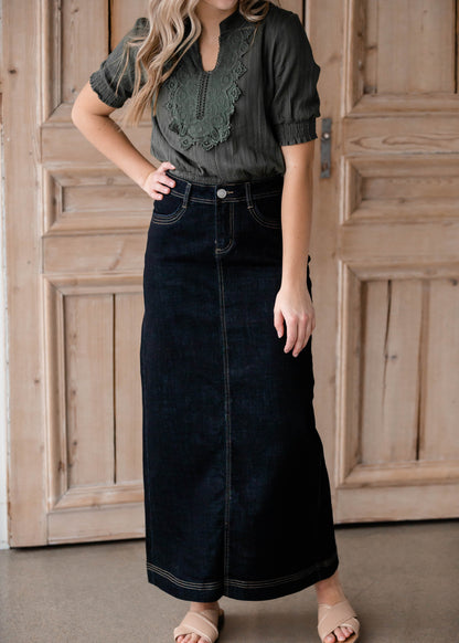 The Beth Dark Wash Long Denim Skirt is an Inherit Design made with you in mind! The dark wash is easy to dress up and details make this a stand out skirt! There is a triple stitch detail on the bottom hem and an Inherit logo patch on the back waistband! A straight fit with a slit in the back makes this long denim skirt super easy to move in and to pair with any tops!