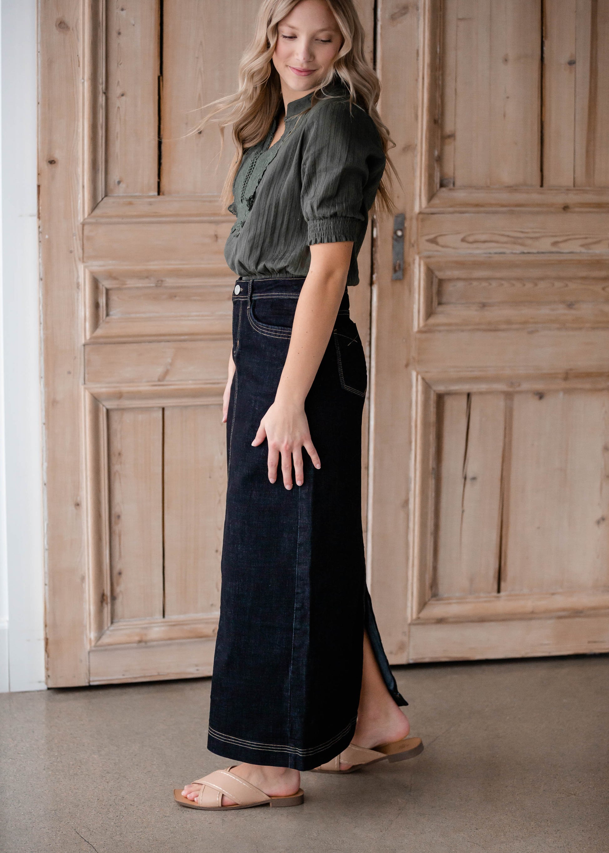 The Beth Dark Wash Long Denim Skirt is an Inherit Design made with you in mind! The dark wash is easy to dress up and details make this a stand out skirt! There is a triple stitch detail on the bottom hem and an Inherit logo patch on the back waistband! A straight fit with a slit in the back makes this long denim skirt super easy to move in and to pair with any tops!