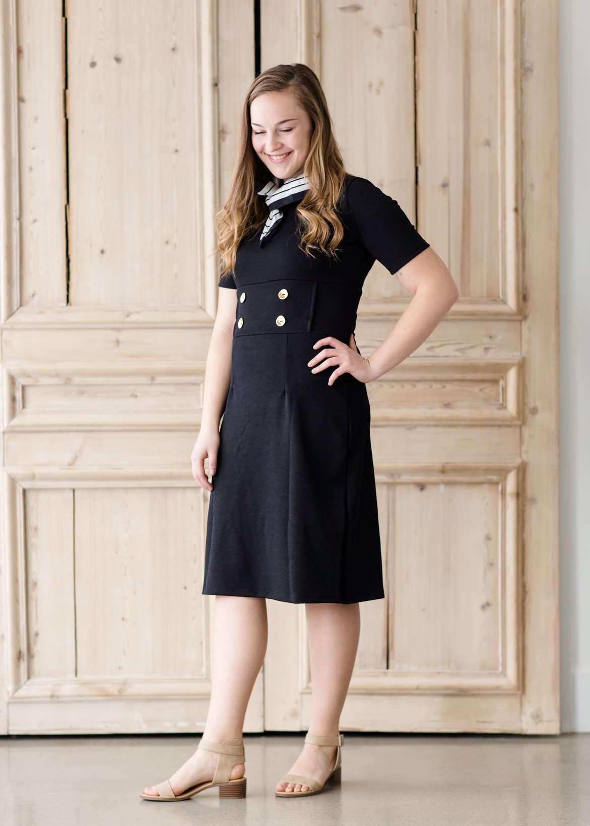 modest black midi dress with gold button accent