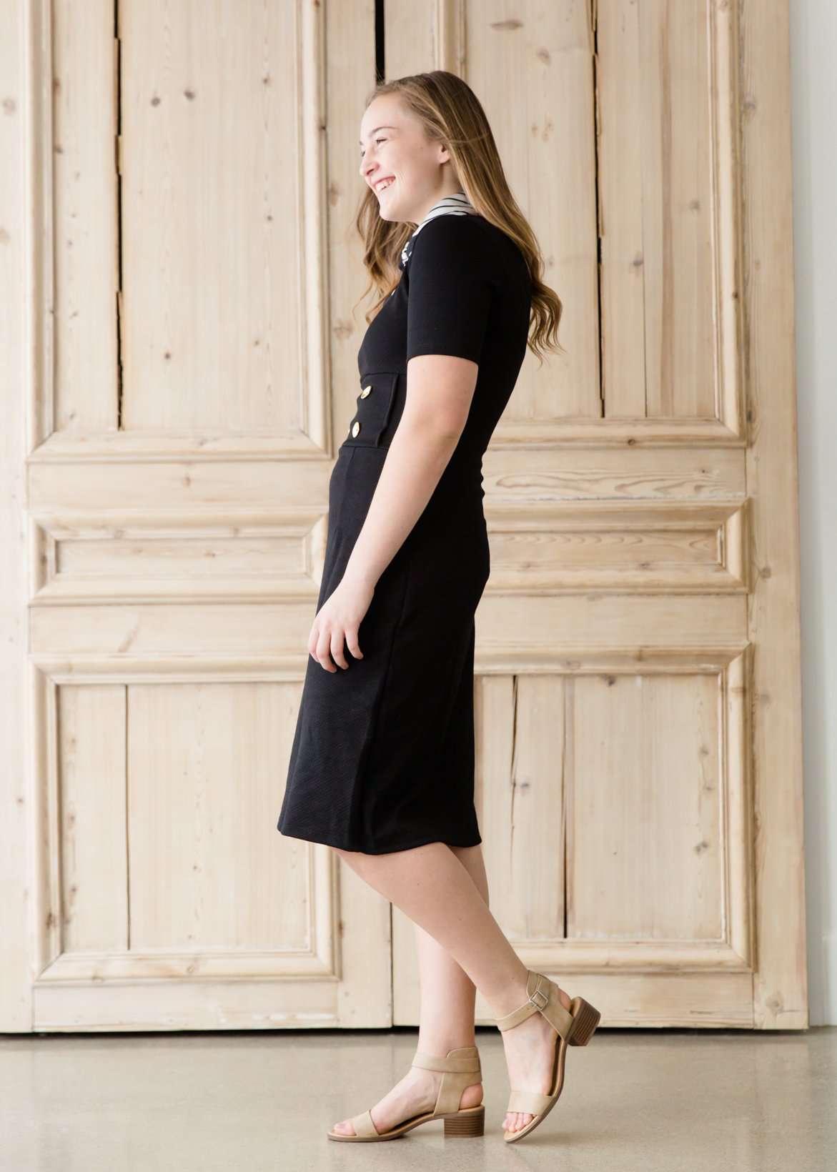 modest black midi dress with gold button accent