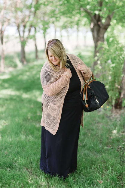 blush or taupe crochet knit cardigan with open front and two side pockets.