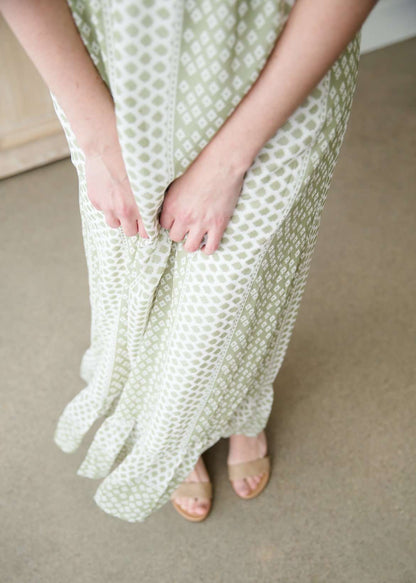 Green polka dot ditsy print maxi dress with flutter sleeves and faux button front