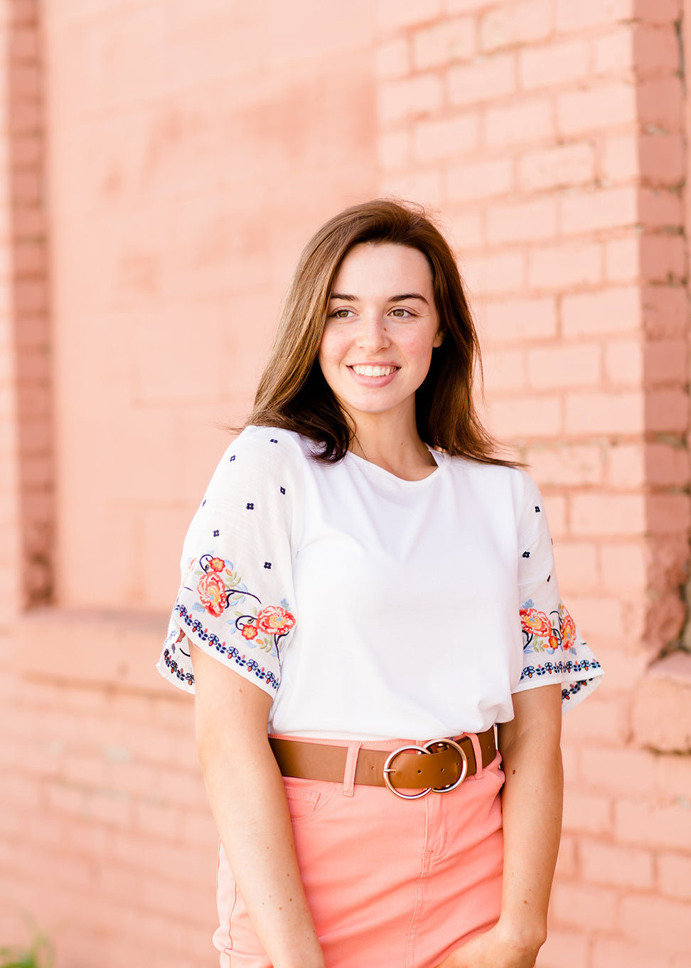 White top with multi color floral embroidered knit sleeves