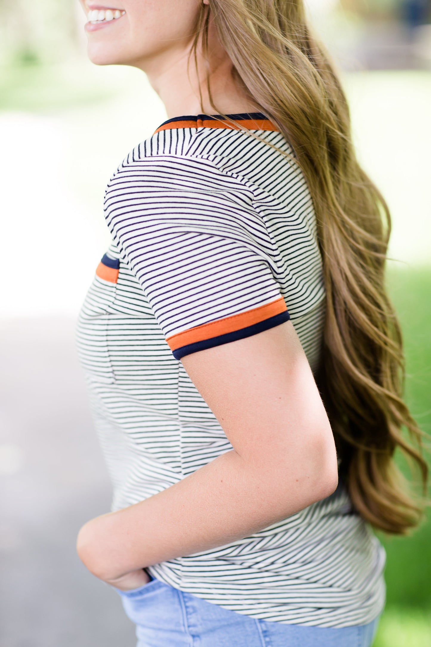 Navy striped tee with a rust accent and front pocket