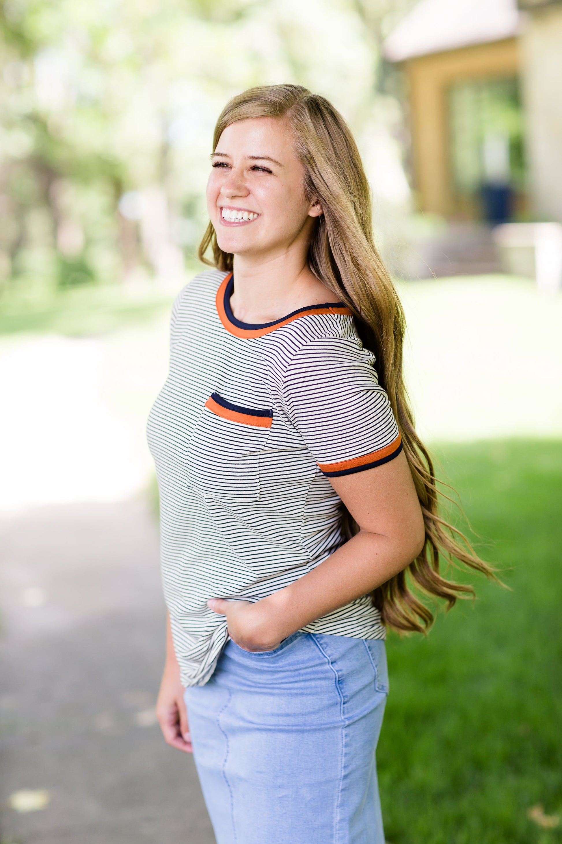 Navy striped tee with a rust accent and front pocket