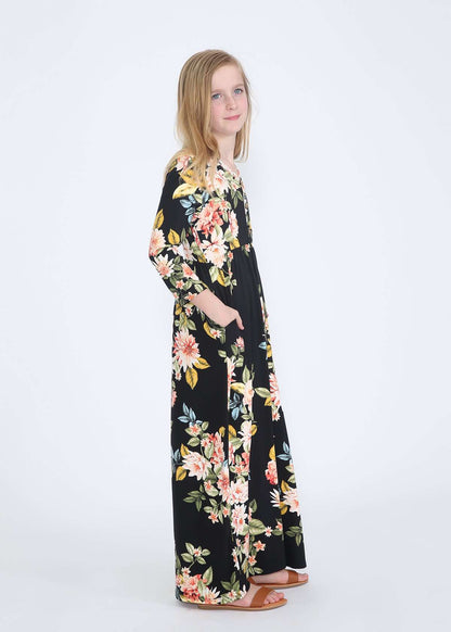 young girl wearing a modest black maxi dress with flowers on it