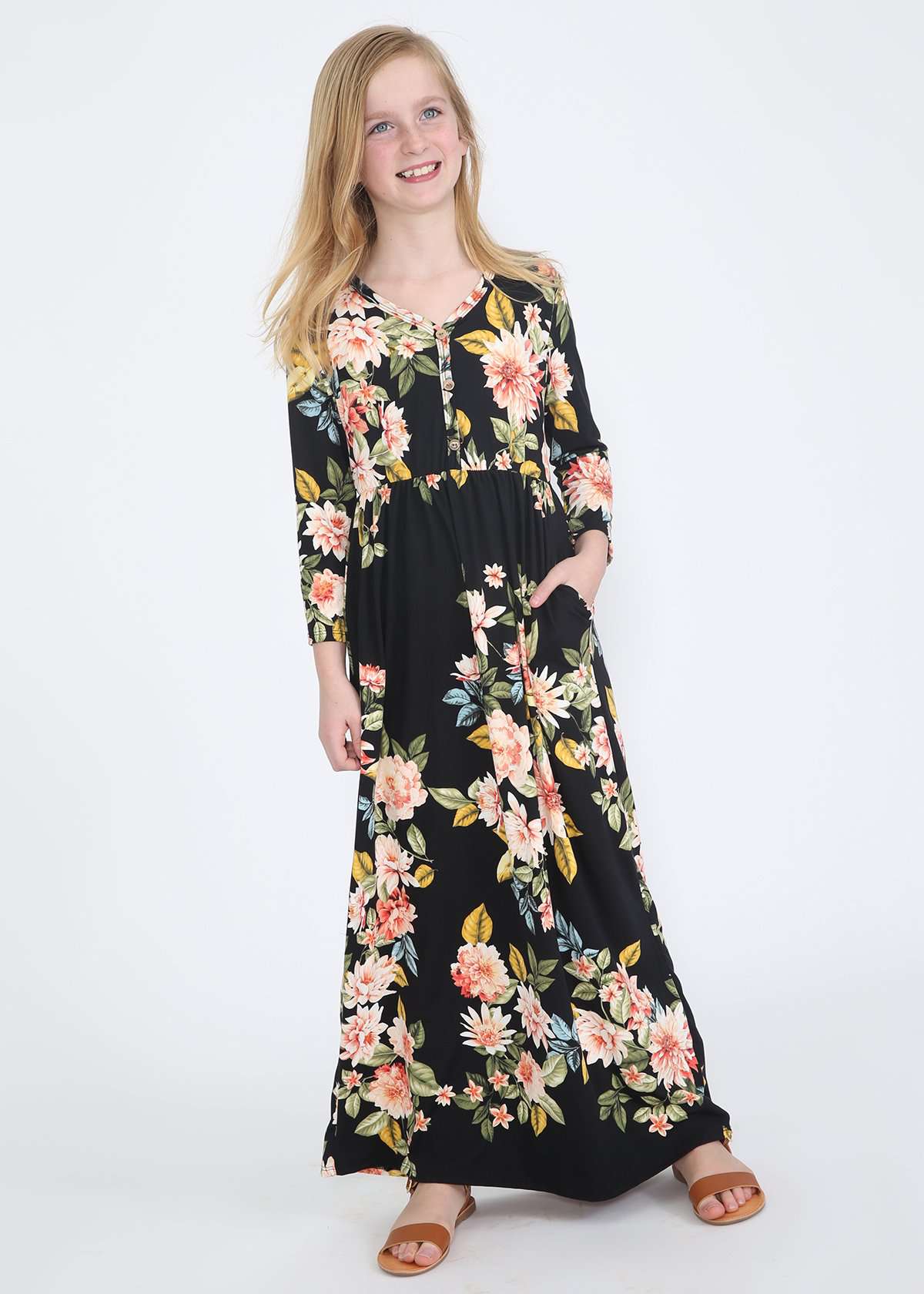 young girl wearing a modest black maxi dress with flowers on it