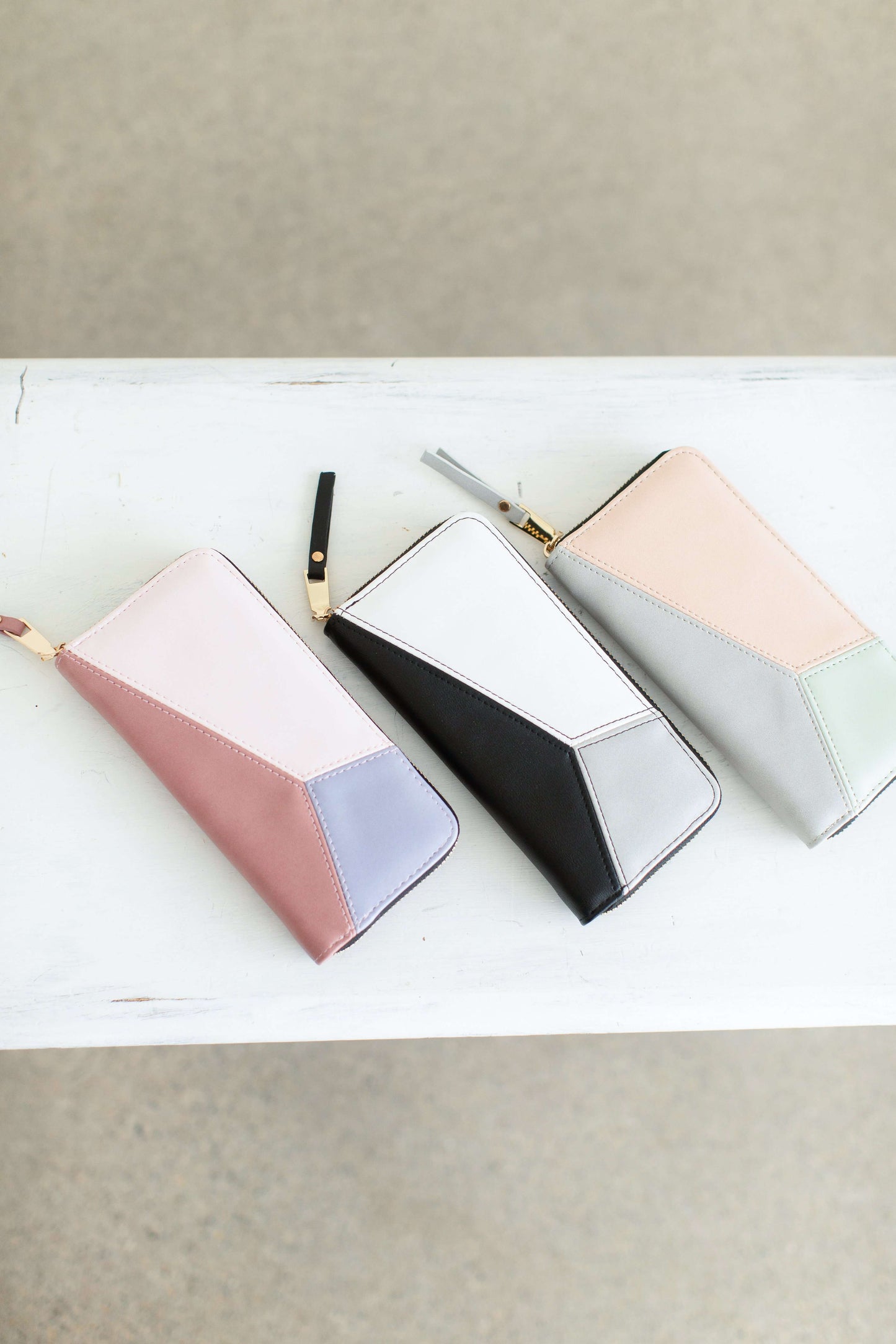 Geometric Zip Wallet in blush, purple, black, peach and mint colors