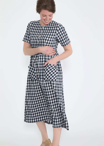 woman wearing a navy and white gingham print midi dress