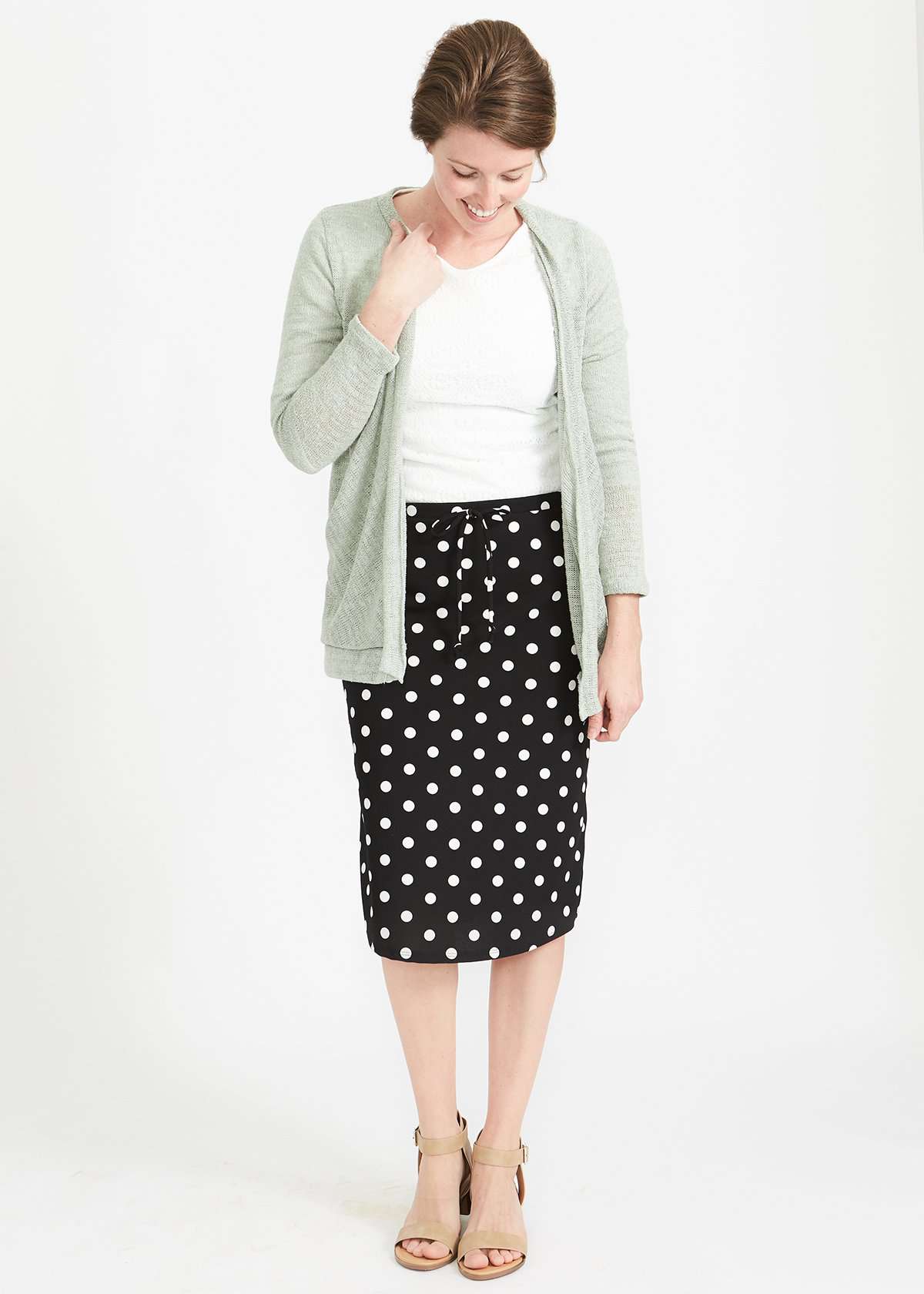 Woman wearing black and white stretch polka dot dress skirt