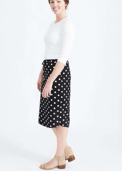 Woman wearing black and white stretch polka dot dress skirt