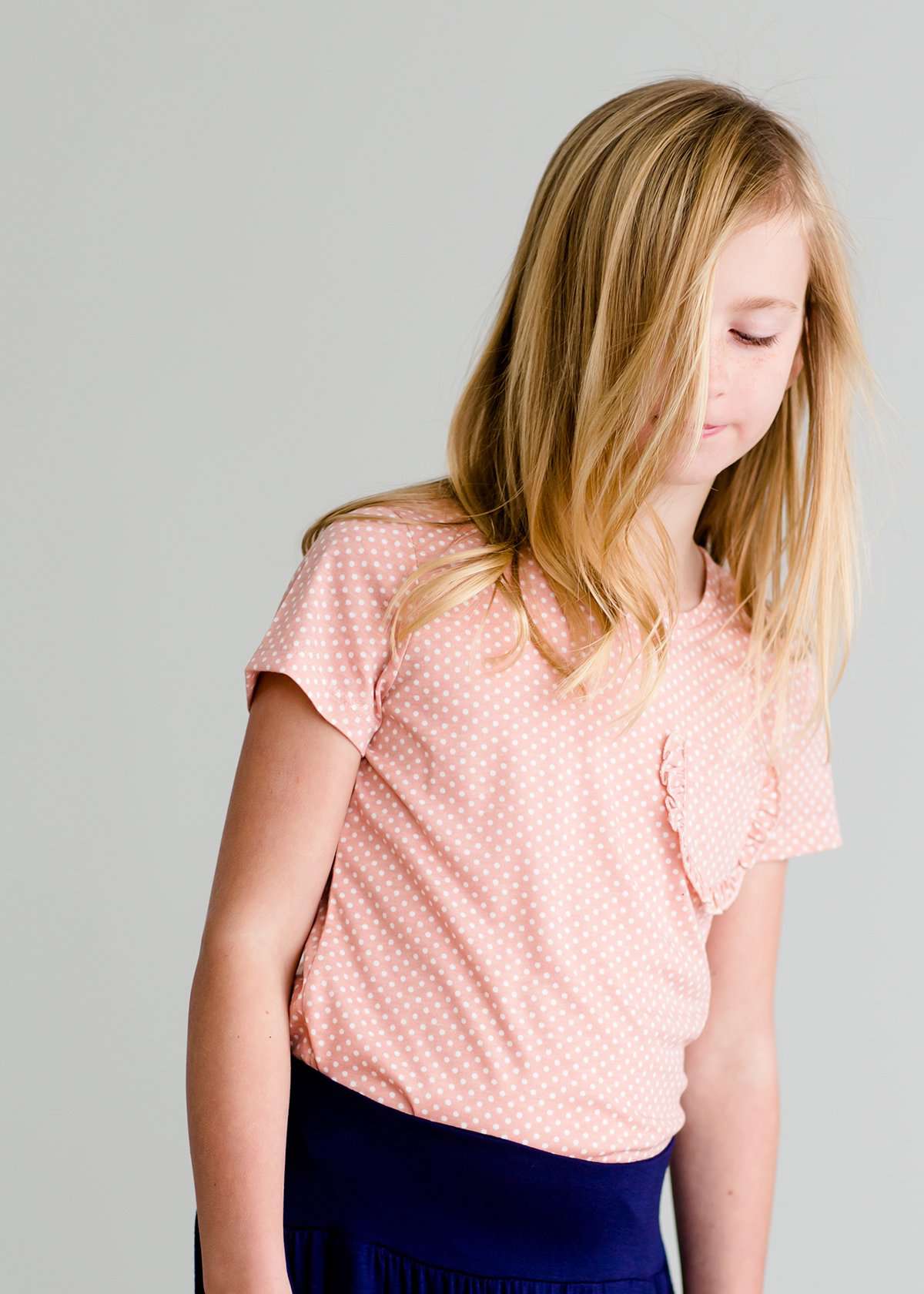 Girls modest blush polka dot tee with a ruffle front pocket